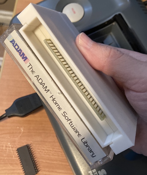 An SMS cartridge shell and the cassette tape are side by side, revealing they are the same size.