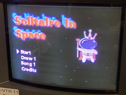The Solitaire in Space title screen. A spaceman with a king crown floats in space. Options are Start, Draw 1, Song 1, Credits.