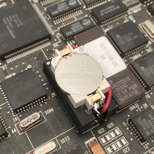 The M48T02 is jammed back into the board, with a battery sticking out of it.