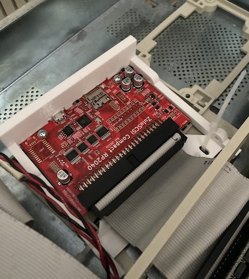 The ZuluSCSI and its adapter plastic, ziptied into the Sun adapter sled.