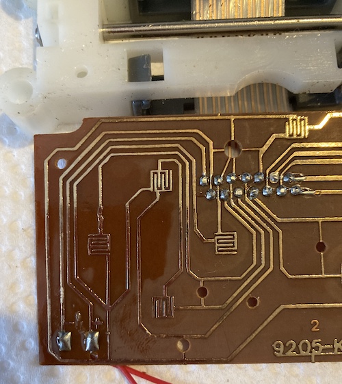 The bottom board, showing the pads for the controls as well as + and - markings with pads for the battery.