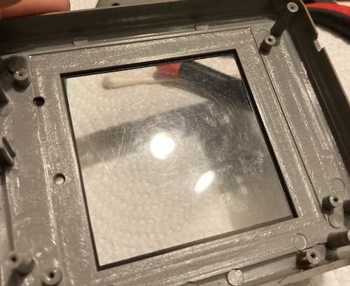 The inside of the screen lens. You can see from the reflection that it has suffered a lot of scratches over the years...