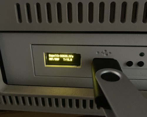 The nasty, jagged hole I cut for the OLED is now on full display with the new screen glowing yellow through it.