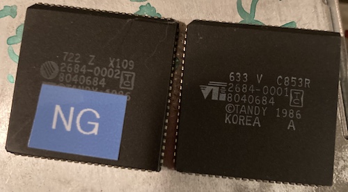 The old chip (a 8040684 2684-0002) next to the new chip (a 8040684 2684-0001). The old chip has an "NG" sticker on it to make double extra sure that future me didn't mix the chips up when he went to swap them. Thanks, past me.