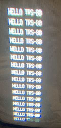The computer indefinitely repeats "HELLO TRS-80"
