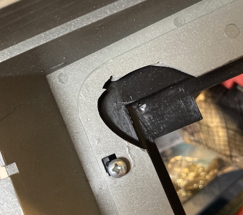 The inside of the top case is missing a big chunk, and a self-tapping Phillips-head screw is replacing one of the mounting tabs.