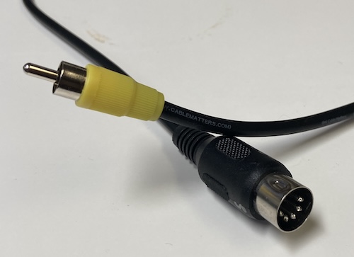 The composite video cable: it's a 5-pin DIN leading to a yellow RCA end.