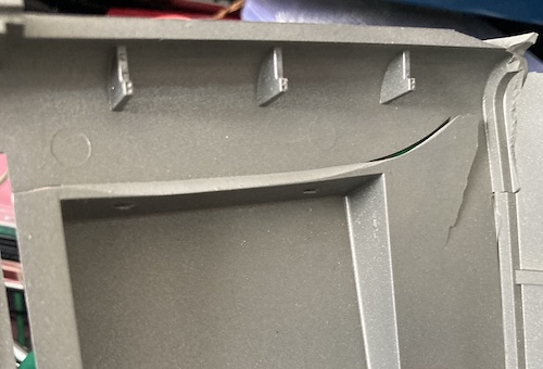 The back case has a huge crack in it that has produced a sort of shear plate formation.