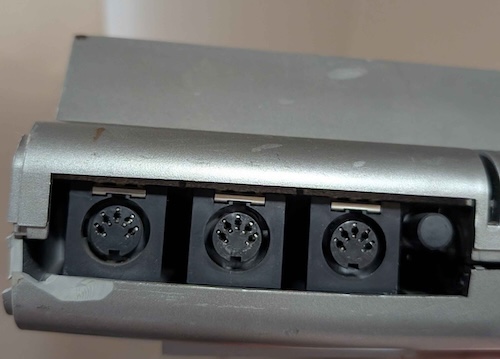 The black plastic insert that covers the ports and labels them is missing.