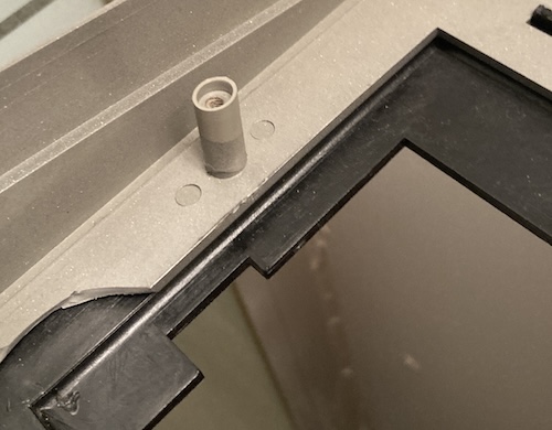 A top case screw post has been glued back in. You can tell there's a distinct difference in shades before and after the repair section.