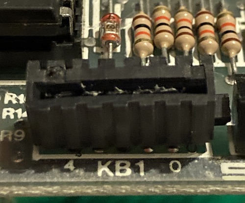 The KB2 connector has some goo inside it and looks slightly melted.