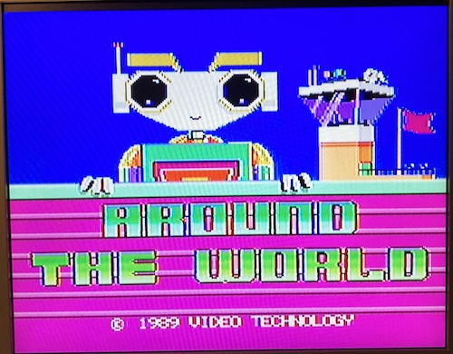 The title screen for "Around the World." A robot stares lifelessly into your eyes as a copyright "1989 Video Technology" floats through the ether. An airport control tower sits in the background.