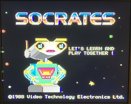The robot now says "Let's Learn And Play Together!" His(?) eyes light up in what could be interpreted as fear, as he slowly comes to realize who he now belongs to.