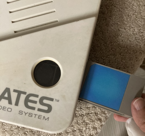 Pulling hard on the thing on the side has removed it, exposing an expansion slot with a window pointing into it.