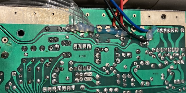 Hot glue is all over the wires running into the PCB.