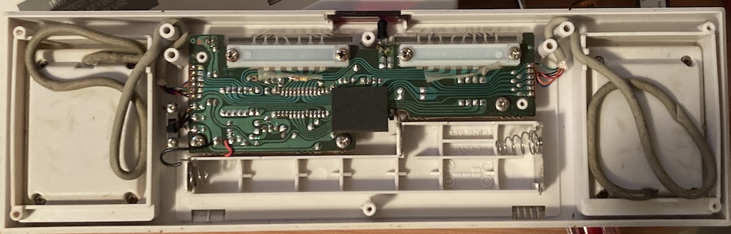 The backside of the keyboard PCB, along with the two controllers stuck into it.