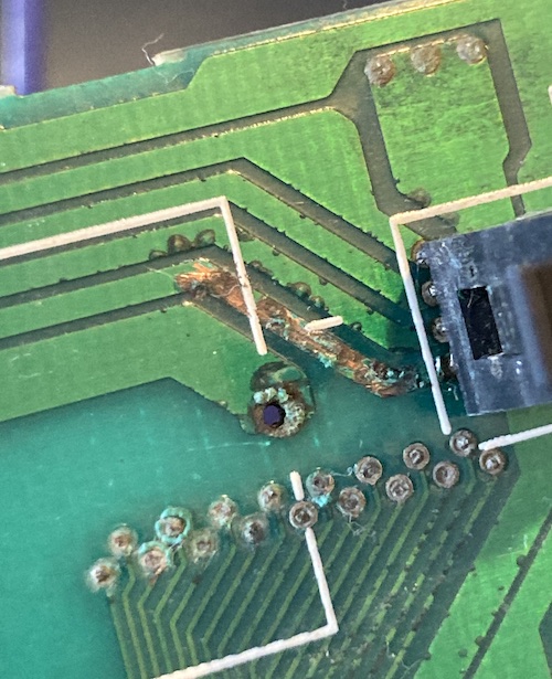 The copper on many vias and traces is blooming with green corrosion.