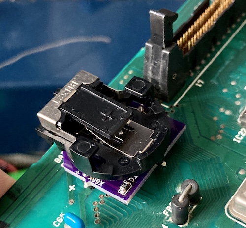 The battery holder PCB installed into the I/O board. You can see that it has a little bit of height added over the original battery, which contributes to the wobble.