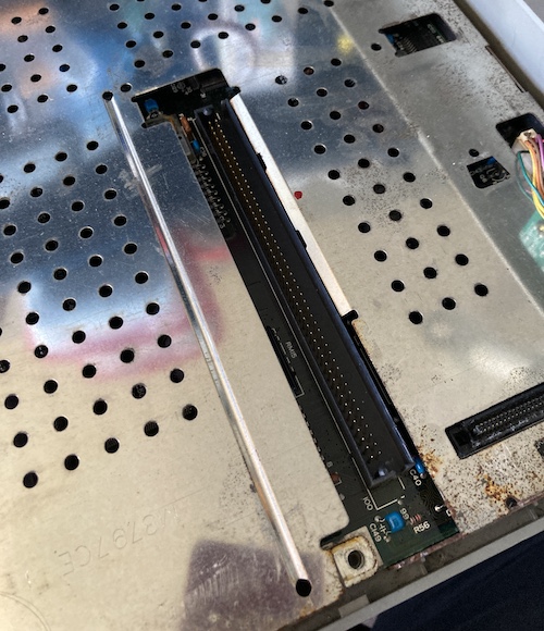 With the card cage removed, a 100-pin connector sticks out of the motherboard. Miraculously, I didn't bend any pins removing it.