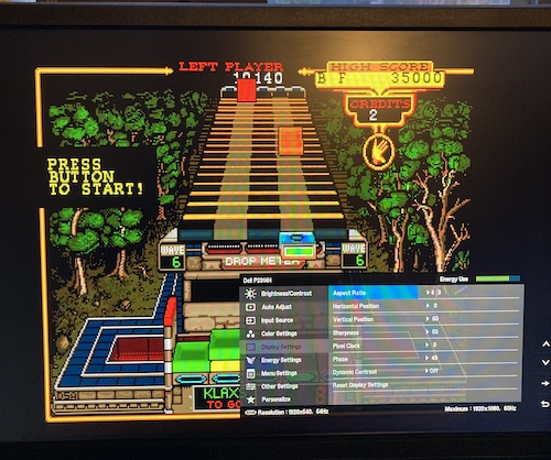 As described, the rightmost yellow border of the game is missing, the game image is not centred, and the adjustment menu and pixel clocks are fully to the left (00) on the horizontal adjustment.