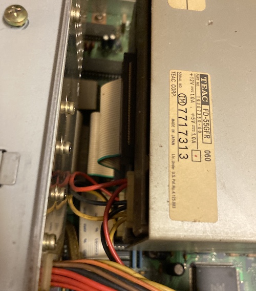 The rear of the floppy drives, showing the data and power cables as well as the info labels.