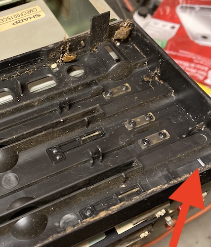 The front fascia in closeup. A red arrow is pointing to the stressed plastic where the broken-off clip used to live.