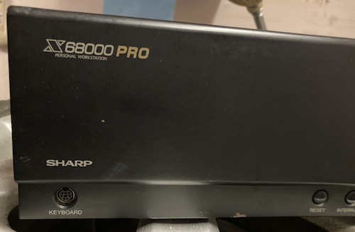 The front panel logo of the X68000 PRO. There are some scuffs and bare metal, but the keyboard port's metal shielding looks OK.