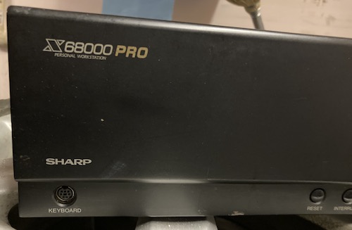 The front panel logo of the X68000 PRO. There are some scuffs and bare metal, but the keyboard port's metal shielding looks OK.