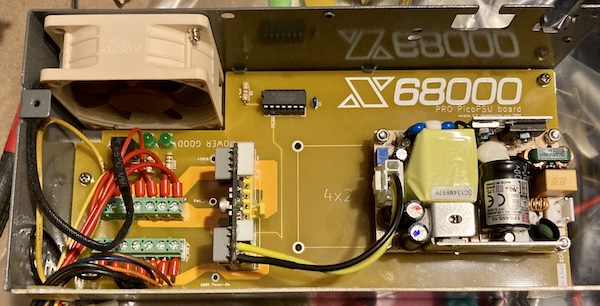 The output harness is wired into the power supply. You can see that a lot of the wires on the top row have a lot of "wasted length" as they head for the exit. Also, the fan cable is very rudely jamming itself into the middle of everything.