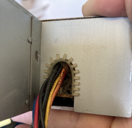 There's so much gunk inside the power supply that it's coming out of the "output" hole.
