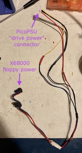 The spliced-together connector. At the top is a callout saying "PicoPSU drive power connector," pointing to a white 4-pin JST SM connector. On the bottom is a callout saying "X68000 floppy power," pointing to a black 3-pin connector of currently unknown type.