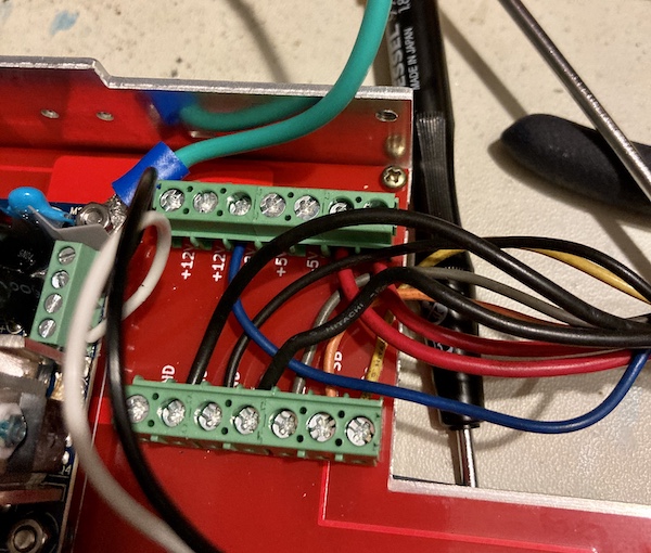 The new low-voltage wiring. The wires are screwed into various screw terminals. There is a lot of wire mess and tight turns in between them.