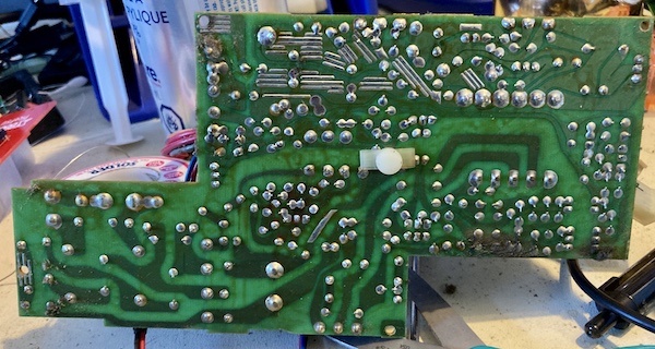 The underside of the X68000 power supply unit, showing the solder joints, traces, and some dirt in the corners.